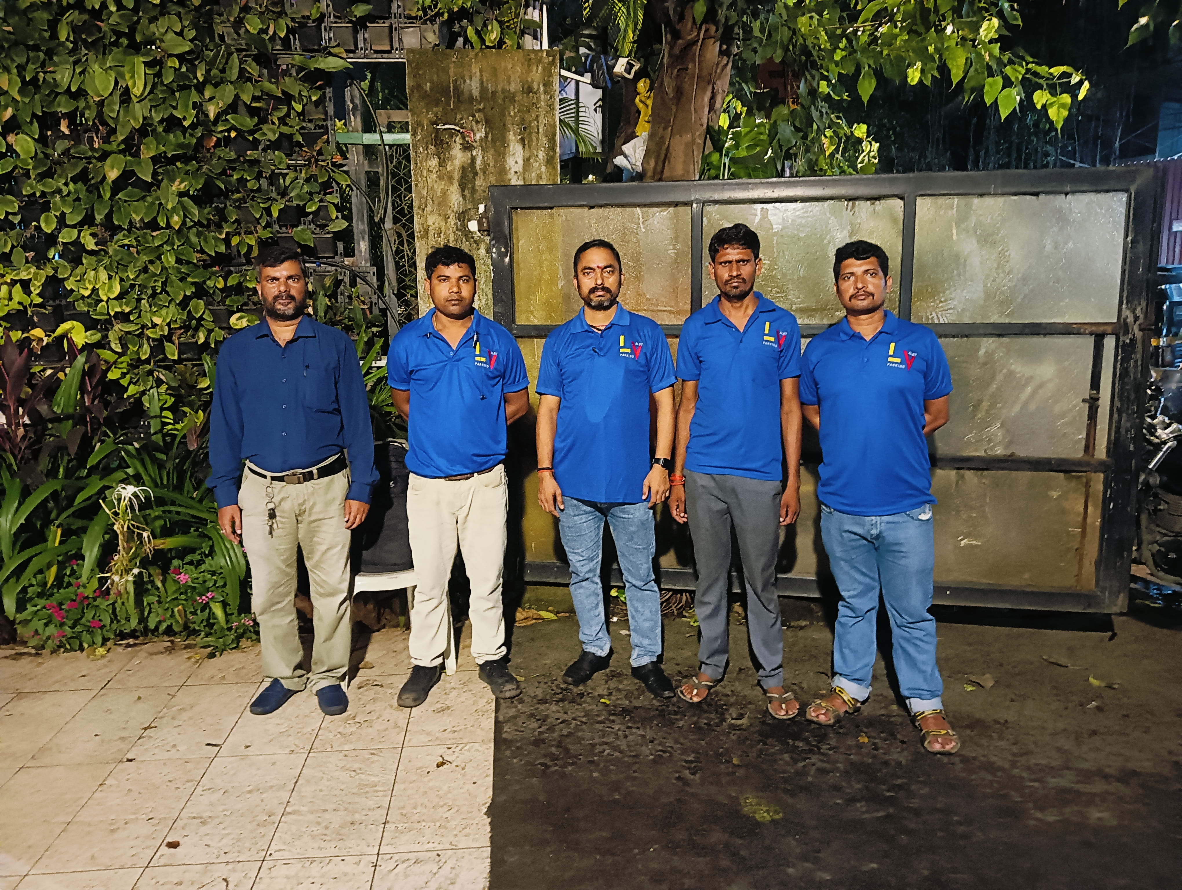 Luxury cars parked by valet staff at an upscale Mumbai event